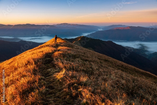 Obraz Photographer with tripod on the mountain top.