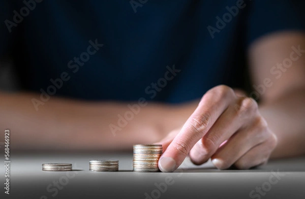 Obraz businessman hold money or golden coin for saving maney wealth and financial concept, business finance investment or financial planning for growing in fund and trading