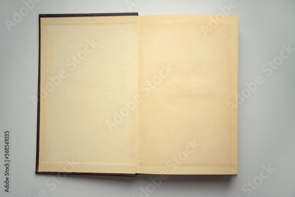 Fototapeta Photo of an open vintage book on the table. Blank sheets of an old book. Vintage pages.