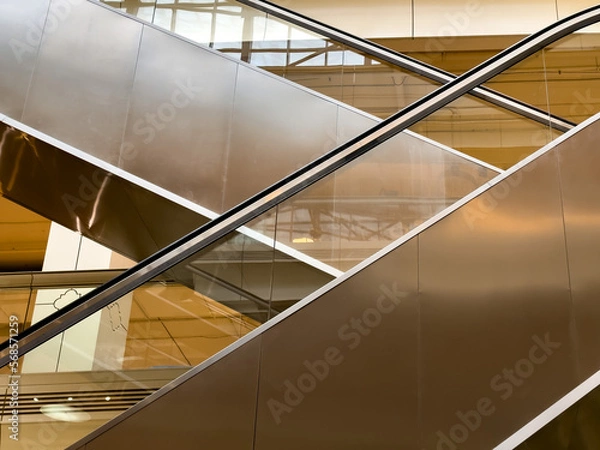 Fototapeta Close-up side view of escalator. Close-up of escalator and handrail