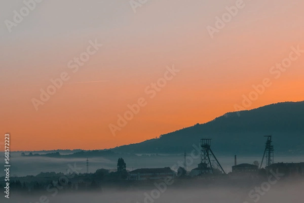 Fototapeta Precious metals and rare earths mine in the middle of the fog at sunset on golden hour
