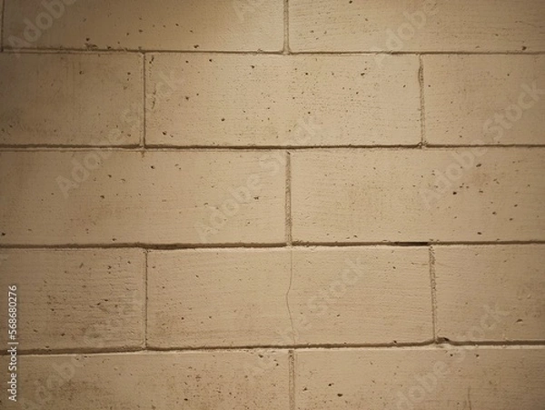 Fototapeta White brick wall background under yellow light