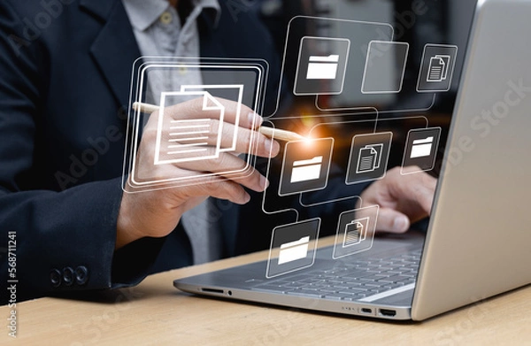 Obraz Businessman using laptop for document management, online document database concept and digital file storage or record keeping software, database technology, file access, document sharing.