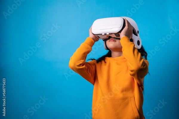 Fototapeta the studio isolated a portrait image of the girl wearing the VR goggle with the technology concept