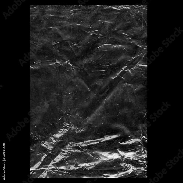 Fototapeta Wrinkled plastic wrap texture on a black background wallpaper.  Royalty high-quality free stock photo image of realistic plastic wrap for overlay, copy space and photo effect. Wrinkled plastic surface