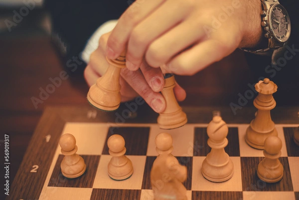 Fototapeta hand with chess pieces making short castle