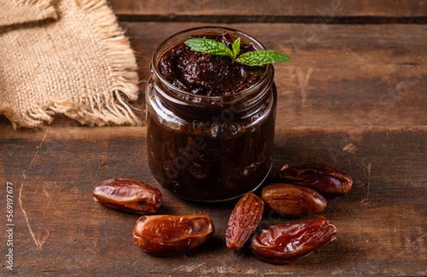 Obraz Useful and delicious date paste served in a glass jar. Homemade date cream paste.