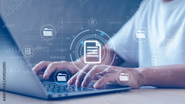 Fototapeta Office worker typing on laptop keyboard showing document management(DMS) system and database ,concept managing various files and online documents of corporate business efficiently with technology