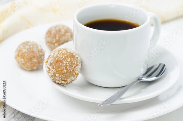 Fototapeta Homemade candy made of almonds, ginger and dates and coffee