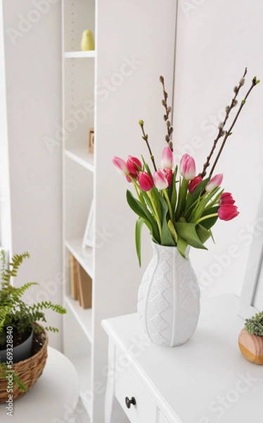 Obraz Vase with tulips and willow branches on table in living room