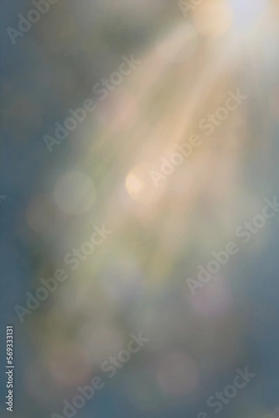 Obraz Blue and gold bokeh with sun ray slanting from the top right.
