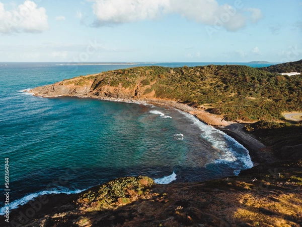 Fototapeta Beautiful island coast with a beach between two green mountains from puerto rico