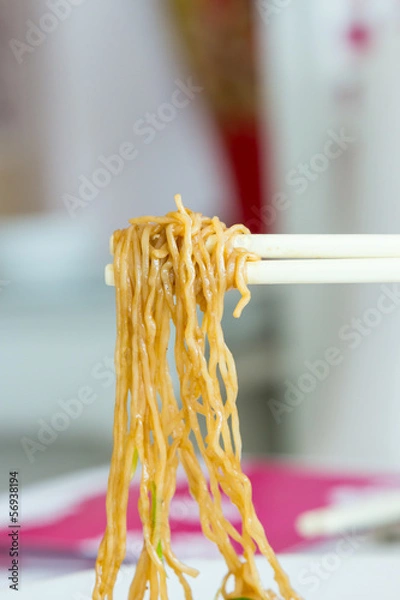 Obraz Yellow noodles with chopstick holding