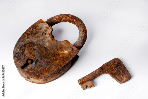Obraz Old rusty lock with a key on a white background