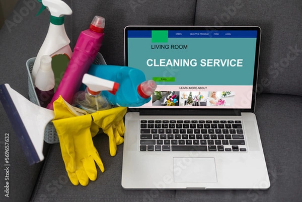 Fototapeta a basket with detergents, a laptop with a cleaning application