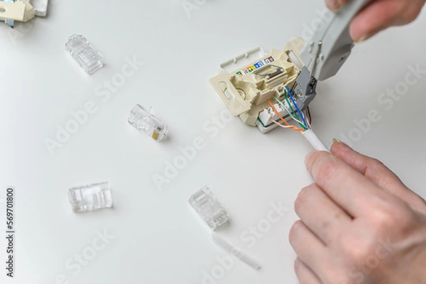 Fototapeta installing a wall ethernet socket. Connecting wires to an socket.