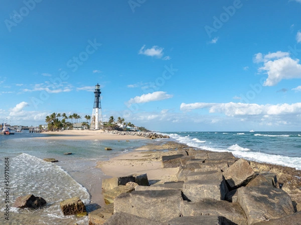 Obraz lighthouse on the beach with palm trees
