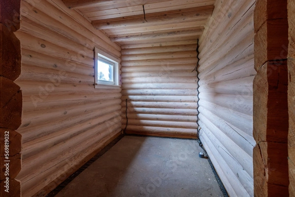 Obraz A two-story wooden cottage from the inside out in coniferous spruce pine green forest