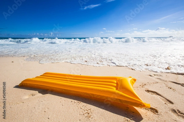 Obraz yellow air mattress before the waves