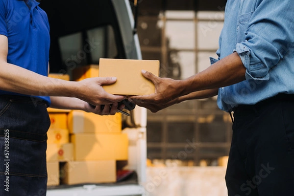 Fototapeta Entrepreneurs Small Business SME Independent men work at home Use smartphones and laptops for commercial checking, online marketing, packing boxes, SME sellers, concept, e-commerce team, online sales