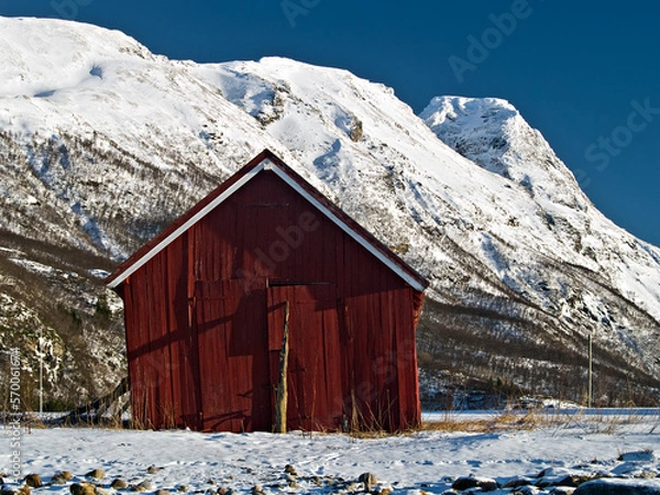 Obraz Old boatshed against winter mountains