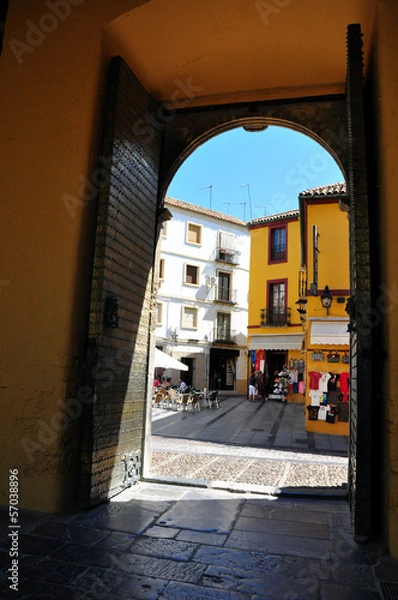 Fototapeta Old town view through Cordoba mosque gate