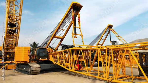 Fototapeta Two big yellow crawler crane assembling the boom and setting up.