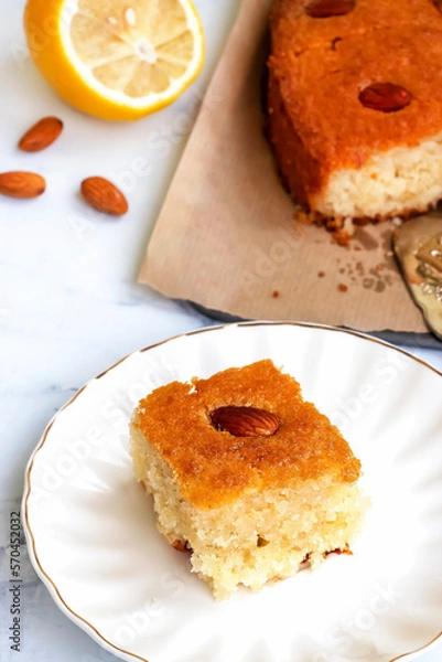 Obraz Basbousa or namoora traditional arabic semolina cake with cashew nuts and syrup. Selective focus.