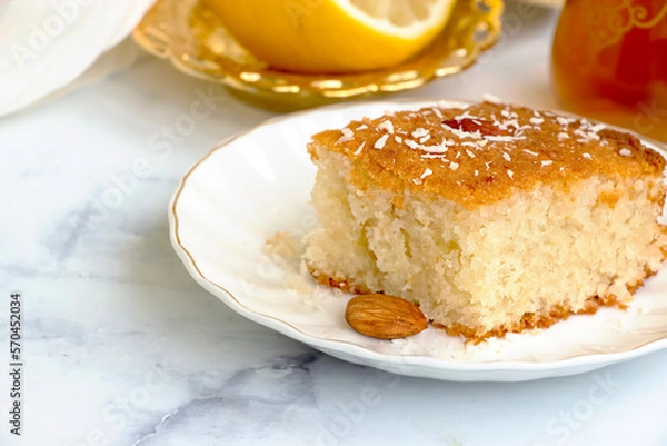 Obraz Basbousa or namoora traditional arabic semolina cake with cashew nuts and syrup. Selective focus.