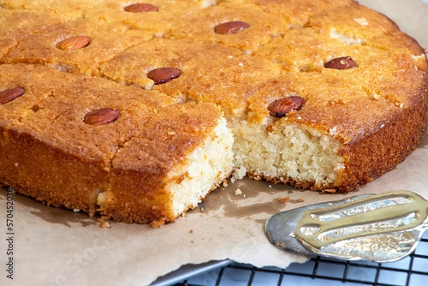 Obraz Basbousa or namoora traditional arabic semolina cake with cashew nuts and syrup. Selective focus.