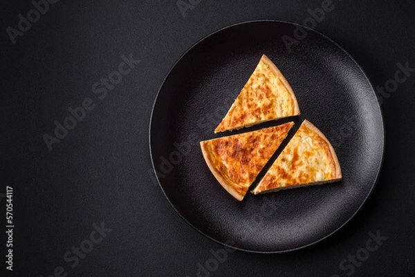 Fototapeta Beautiful delicious quiche pie with four types of cheese with spices and herbs