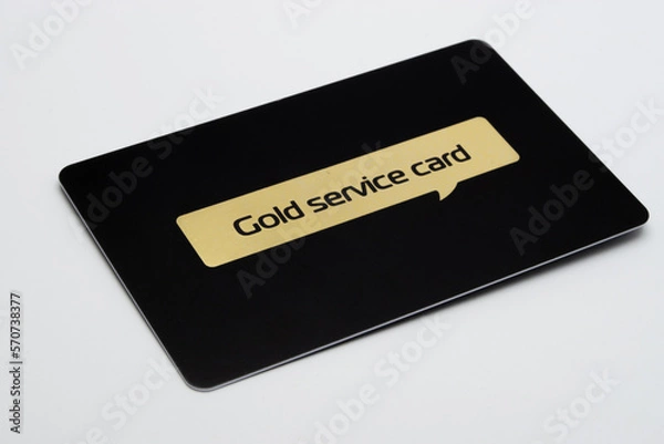 Fototapeta a black plastic gold card on a white background