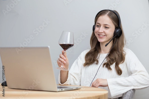 Fototapeta beautiful girl doing team building at home with laptop and drinking red wine
