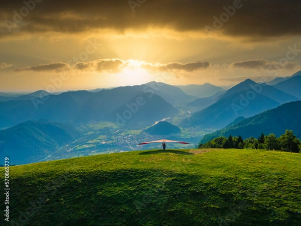 Obraz Hang glider ready to launch from the green meadow in the mountains