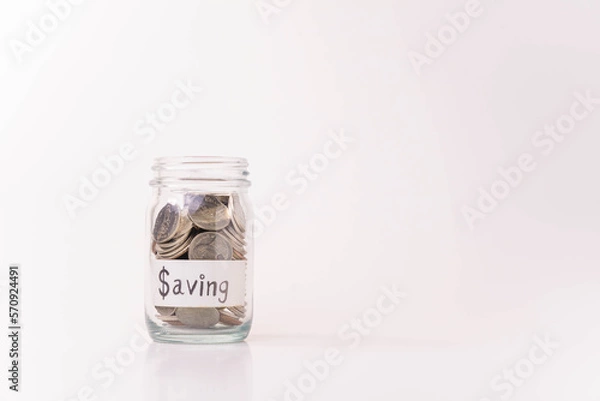 Fototapeta Pile of money coins in piggy bank with white background, saving money and financial concept, copy space