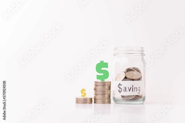 Fototapeta Pile of money coins in piggy bank with white background, saving money and financial concept, financial growth, copy space