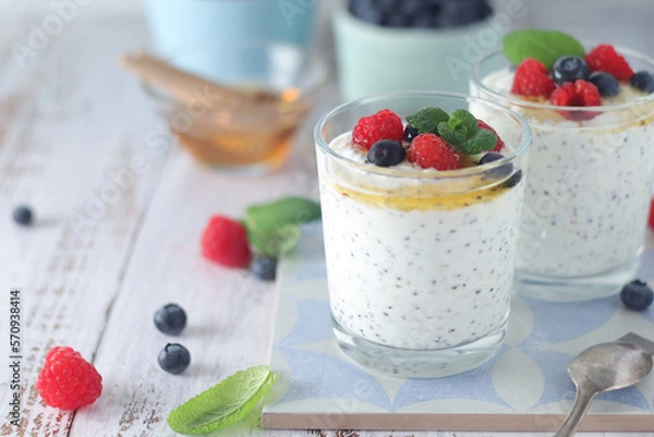 Obraz Greek yogurt in glasses with berries and quinoa