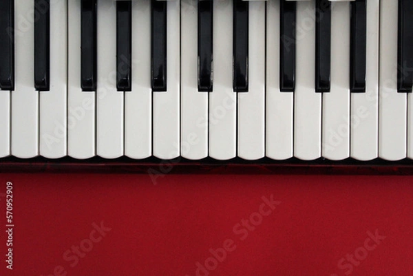 Obraz Piano keyboard on a red background