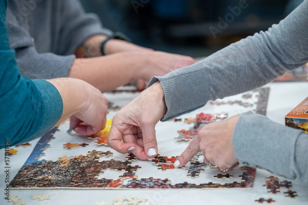 Fototapeta person working on a puzzle