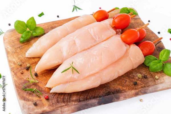 Fototapeta Raw chicken inner on skewers with tomatoes white background with spices, herbs.Raw uncooked Chicken meat,kebab on skewers.skewers raw meat and vegetables.Top view.Chicken Skewers breast fillet meat.