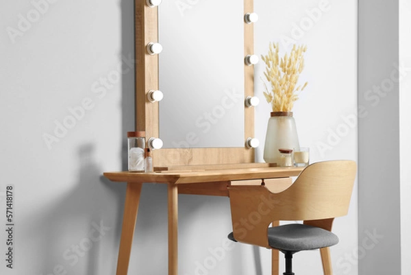 Fototapeta Dressing table with stylish mirror, dried reeds and other decorative elements. Interior design