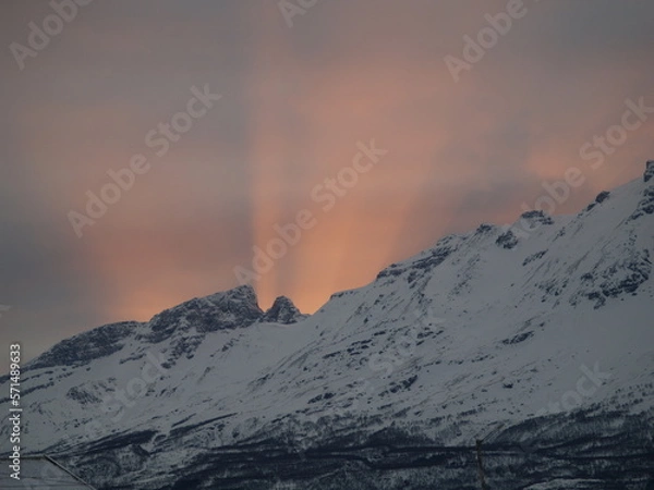 Obraz Rays of sunlight coming up back mountains in Northern Norway