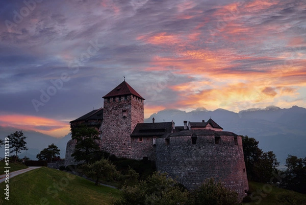 Fototapeta Vaduz Castle, the official residence of the Prince of Liechtenstein, with Alps mountains in background on sunset.