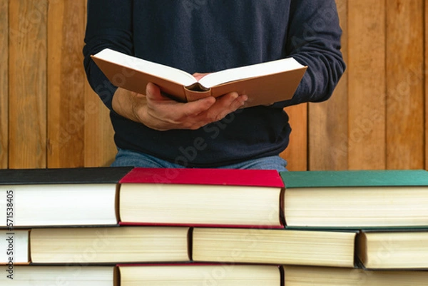 Obraz man holding and reading a book