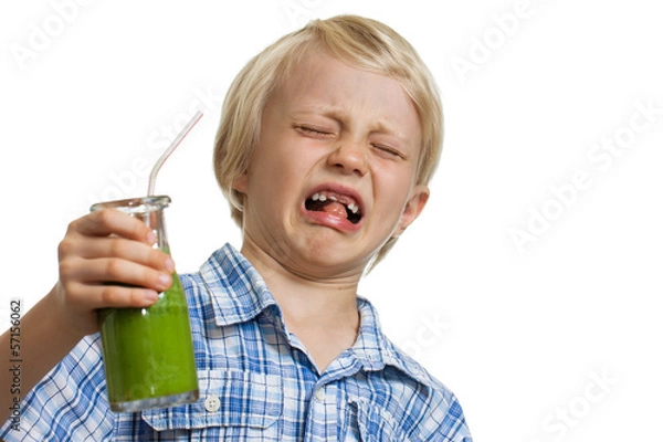 Obraz Boy pulling funny face holding green smoothie