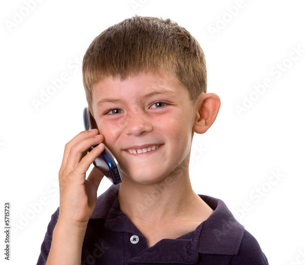 Fototapeta Young boy on a cell phone happy