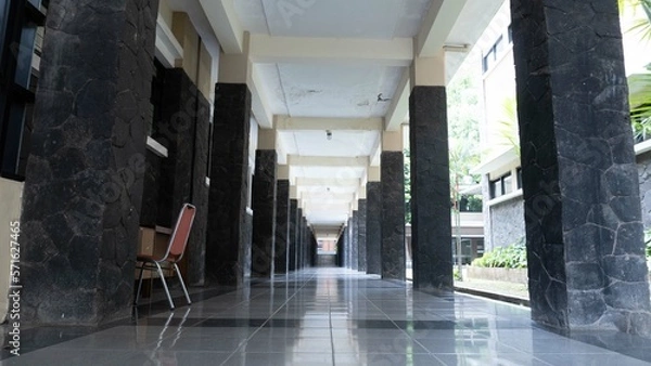 Obraz Empty alley in the old building of an university shot on the day