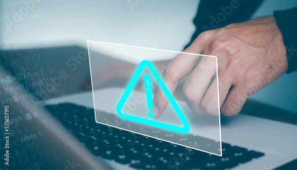 Fototapeta Businessman working on laptop computer at office with exclamation alarm caution warning notification mark Sign, computer virus detected
