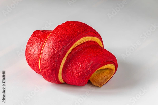 Obraz Red croissant close-up on a light background