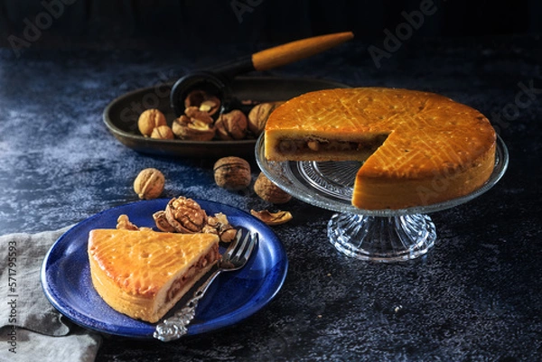 Obraz Engadine Walnuts Torte or Buendner Nusstorte on glass plate, a Swiss confectionery spacialty in Grisons - dark and moody